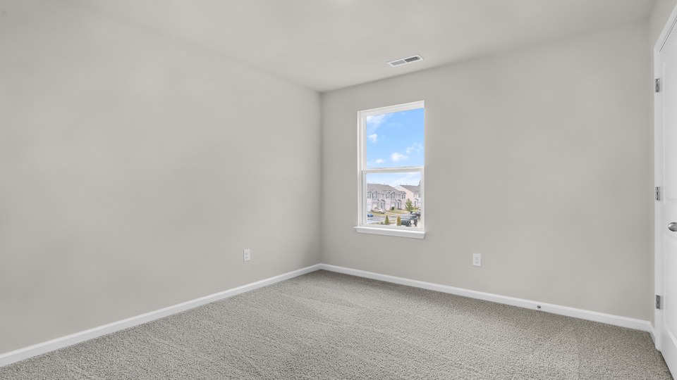 additional bedroom with window, carpeting, closet