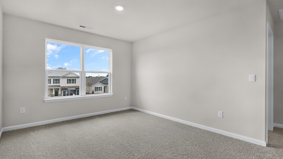 upstairs loft area with large windows and carpeting