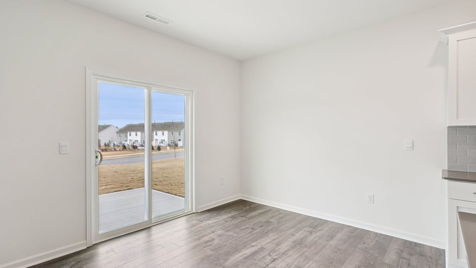 open concept dining space with door to patio