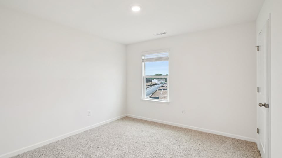 additional bedroom with window, carpeting, closet
