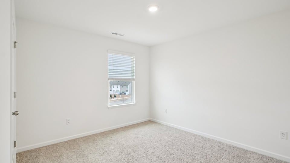 additional bedroom with window, carpeting, closet