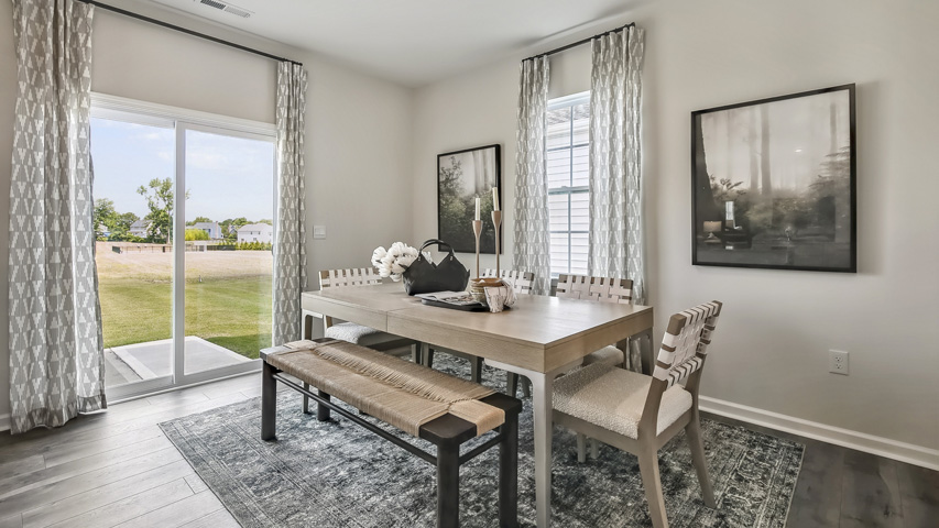 open concept dining space with sliding glass door to patio