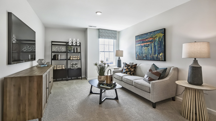 upstairs loft area with large windows and carpeting