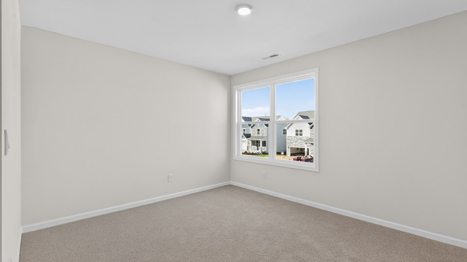 upstairs loft area with large windows and carpeting