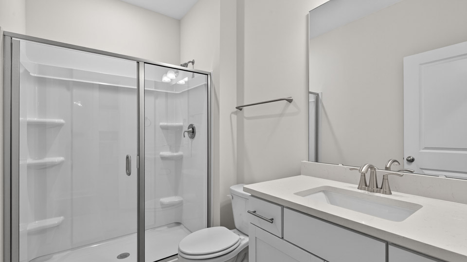 bathroom with walk in shower and single vanity sink