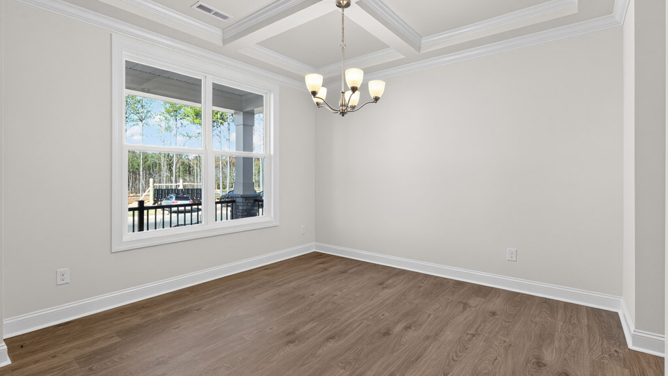 formal dining room with coffered ceilings