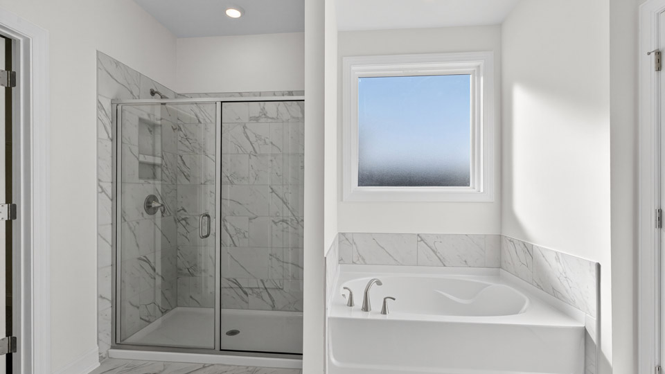 Primary bathroom with double sink and walk-in shower & Tub