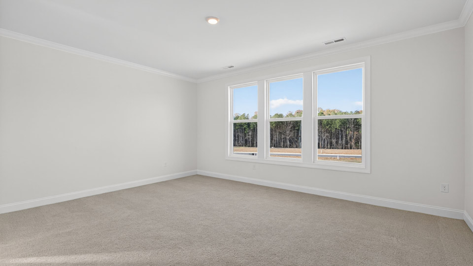 bedroom with carpet flooring and plenty of natural lighting