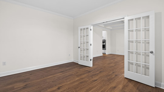 study with french glass doors and revwood flooring