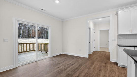 breakfast area with sliding glass doors and revwood flooring