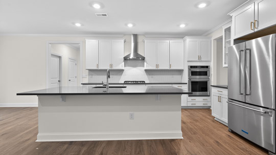 kitchen with island quartz countertops and stainless steel appliances