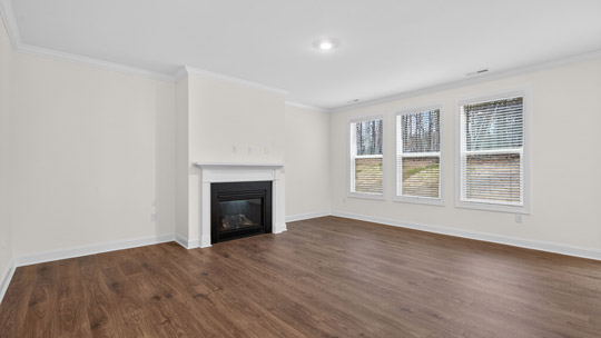living room with revwood flooring and fireplace
