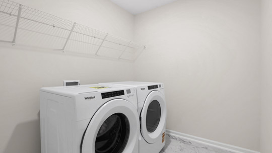 laundry room with washer and dryer and wire shelving