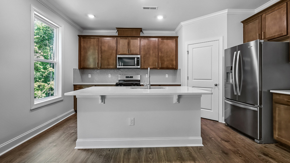 kitchen with island brown cabinets and stainless steel appliances