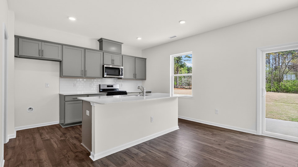 Kitchen with gray cabinets and stainless steel appliances.