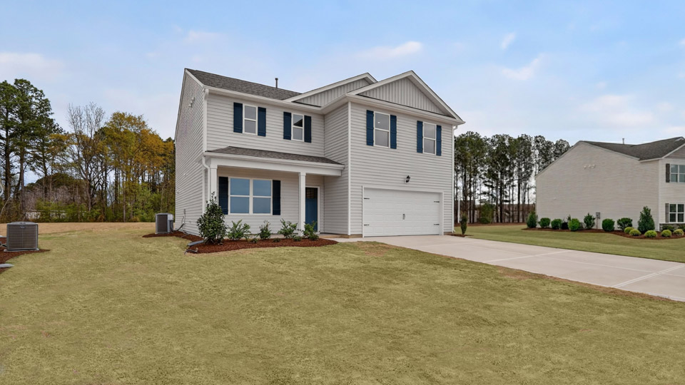 Two story home with white colored siding with a two car garage