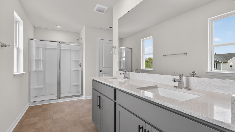 Primary bathroom with double sink and walk-in shower