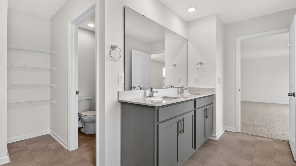 Primary bathroom with double sink and walk-in shower