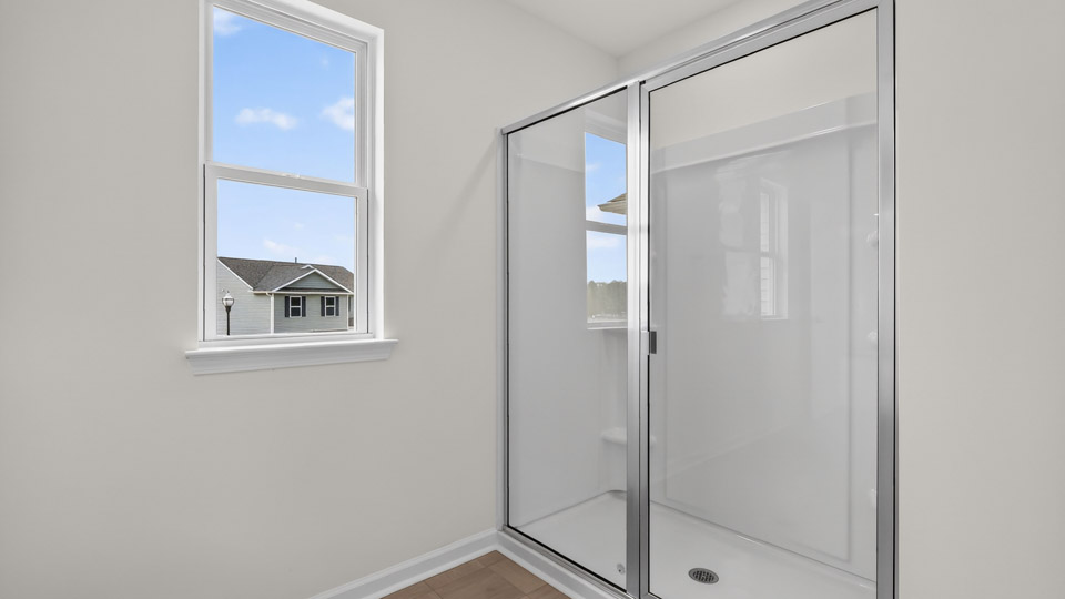 Primary bathroom with double sink and walk-in shower