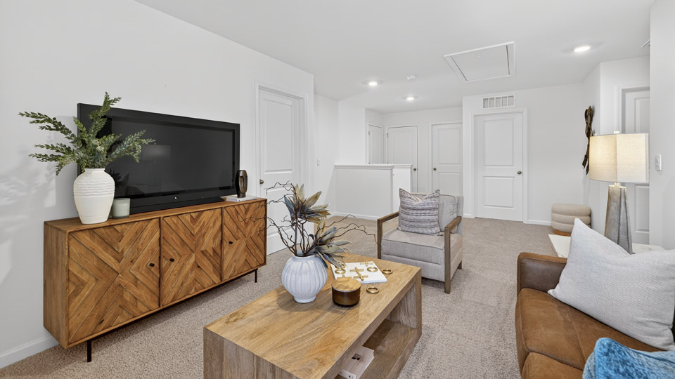 upstairs loft area with large windows and carpeting