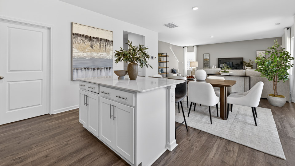 kitchen with quartz counters, kitchen island, pantry, stainless steel appliances