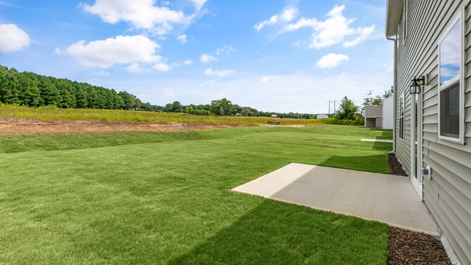 exterior patio with concrete slab and open yard