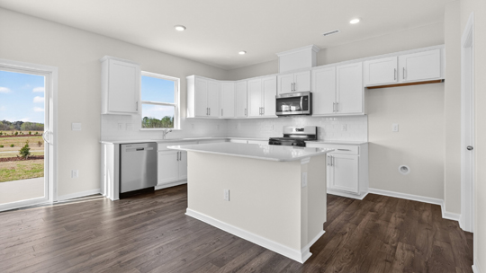 kitchen with white cabinets quartz countertops and island