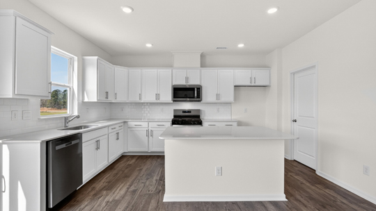 kitchen with white cabinets quartz countertops and island
