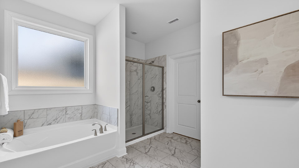 Primary Bathroom with double sinks and a tub and shower