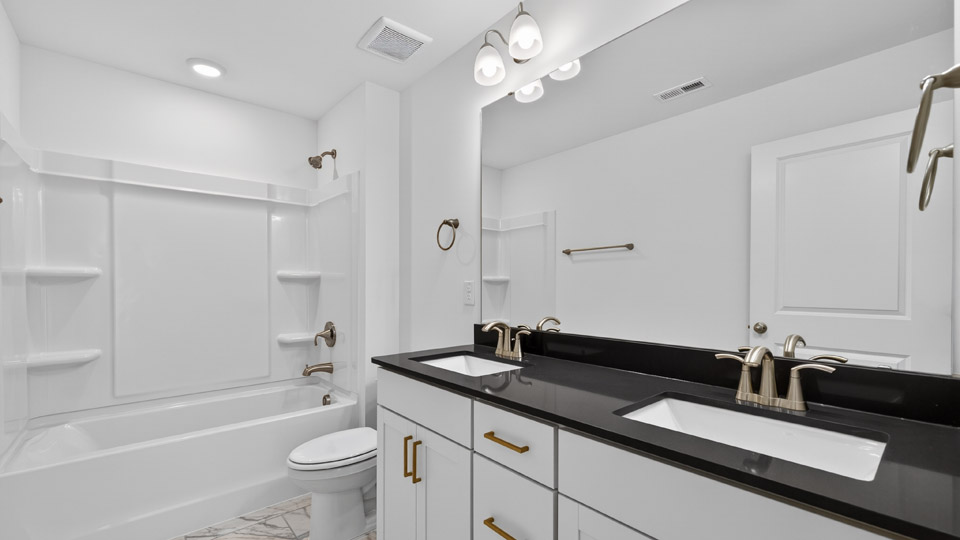 Bathroom with double sink and tub