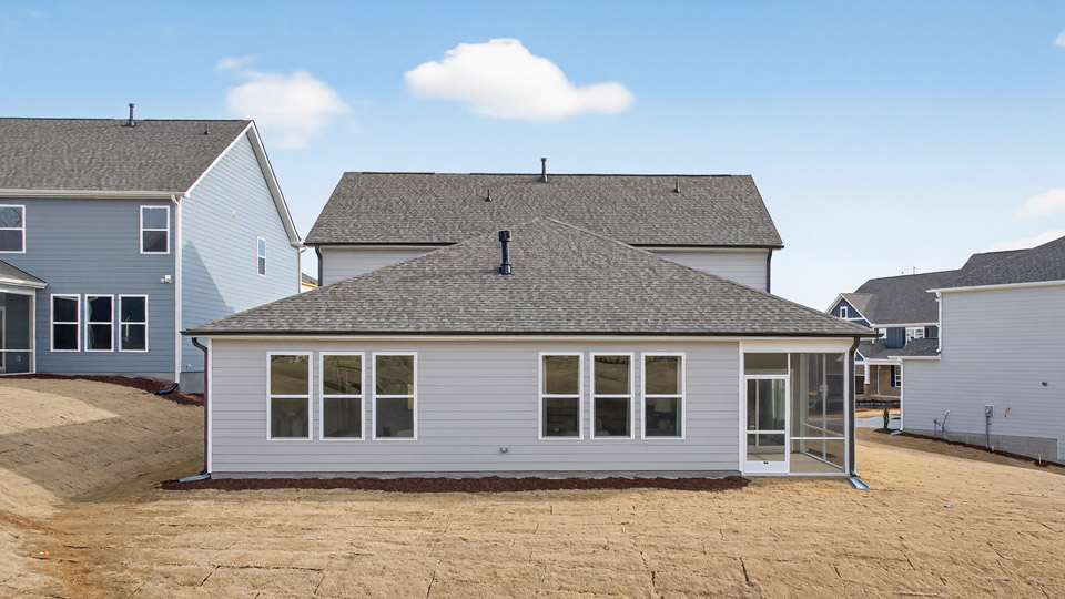 Two story home with view of backyard