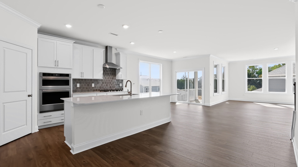 kitchen with spacious island white cabinets and quartz countertops