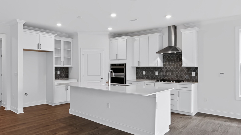 kitchen with spacious island white cabinets and quartz countertops
