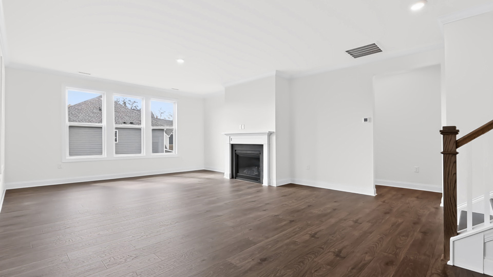 living room with revwood flooring and fireplace
