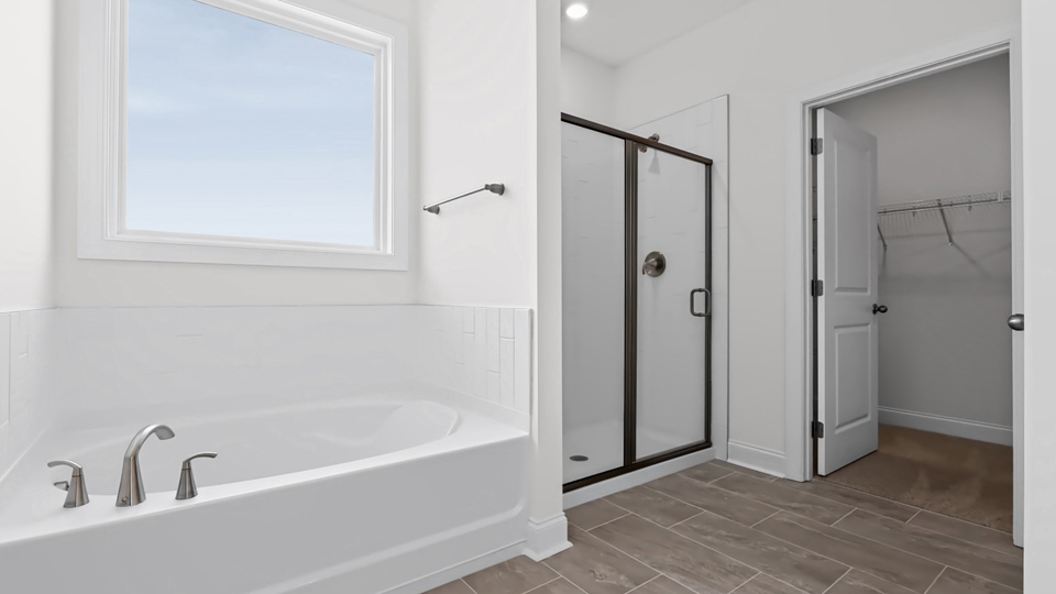 bathroom with separate tub and walkin glass door shower