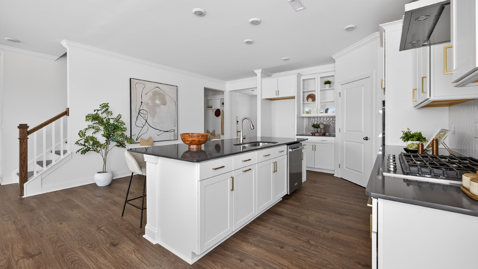 kitchen with quartz counters, kitchen island, pantry, stainless steel appliances