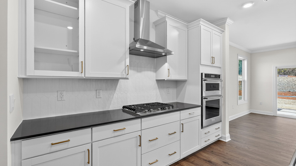 kitchen with quartz counters, kitchen island, pantry, stainless steel appliances