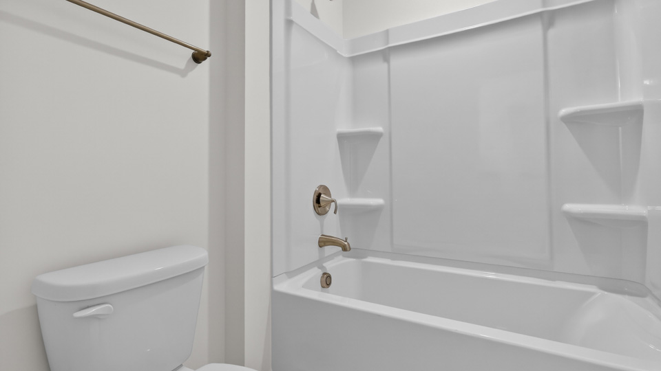 secondary bathroom with shower tub combo and dual vanity sink