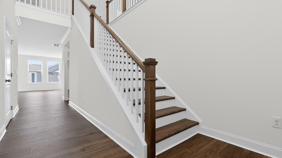 bottom of staircase at front door entry