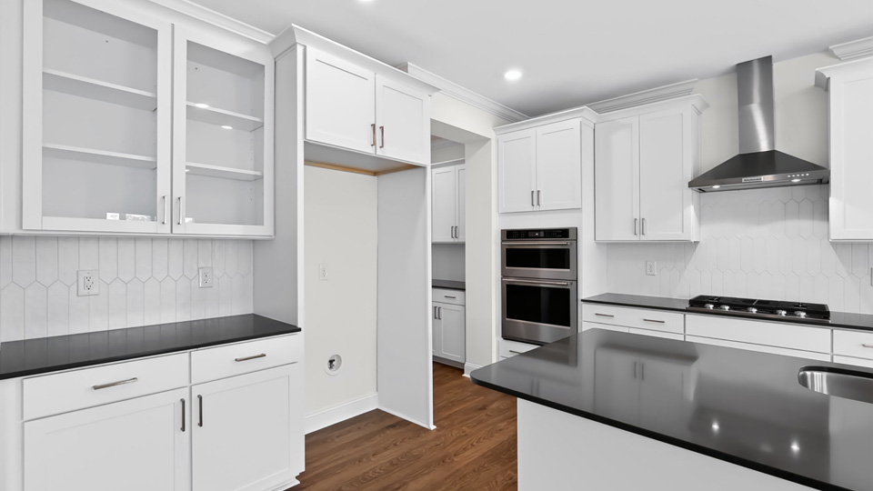 kitchen with quartz countertops island and white cabinets