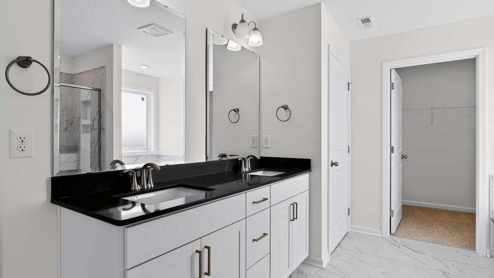 primary bathroom with dual vanity and quartz countertops