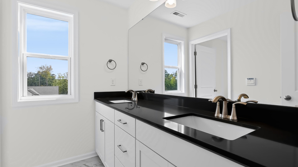 bathroom with quartz countertops and white cabinets