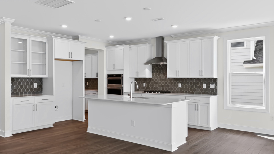 kitchen with white cabients quartz countertops and spacious island