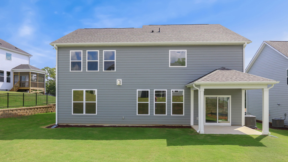 back of home with covered concrete patio
