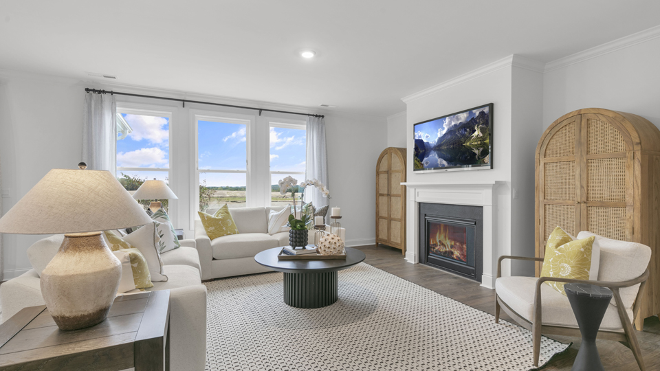 open concept living space with large windows, fireplace
