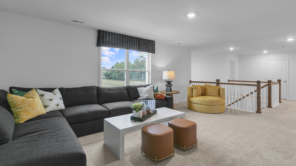 upstairs loft area with large windows and carpeting
