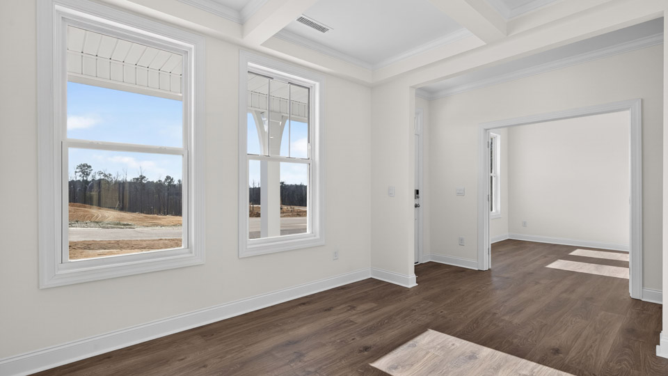 Dining room area with hardwood floor and windows