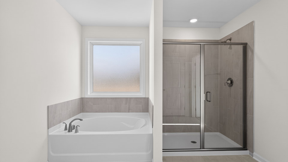 Primary bathroom with walk-in shower and double sink