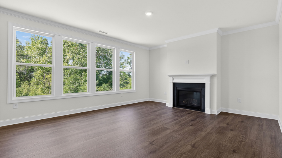 living room with revwood flooring and fireplace
