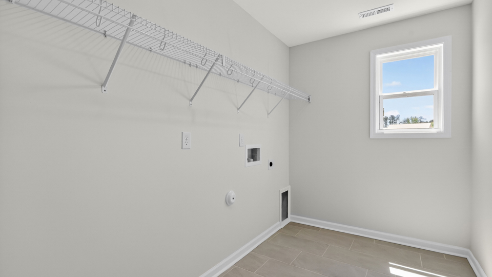 laundry room with washer and dryer hookups and wire shelving